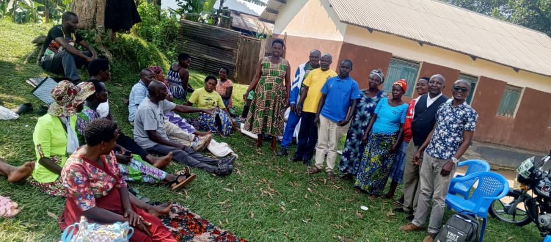 Conservation Village team meeting with a forest-edge community group outdoors for a conservation dialogue
